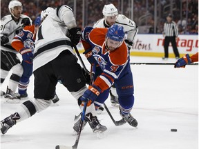 Edmonton's Kris Russell (4) battles LA's Anze Kopitar (11) during the first period of a NHL game at Rogers Place in Edmonton, Alberta on Thursday, December 29, 2016. Ian Kucerak / Postmedia