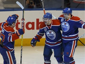 Edmonton's Mark Letestu (55) celebrates a goal with Connor McDavid (97) and Leon Draisaitl (29) during the third period of a NHL game between the Edmonton Oilers and the Winnipeg Jets at Rogers Place in Edmonton, Alberta on Sunday, December 11, 2016. Ian Kucerak / Postmedia