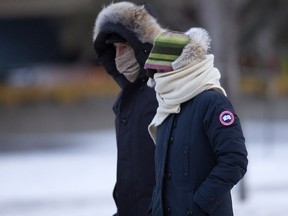 Pedestrians make their way through the bitter cold, in the University area of Edmonton on Tuesday Dec. 6, 2016. Windchill made it feel like -27.