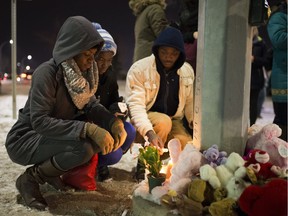 Family and friends of Mariama Sillah hold a vigil for her on Friday, Dec. 2, 2016 at the location where she was killed by an ETS bus on Nov. 26 in Edmonton.