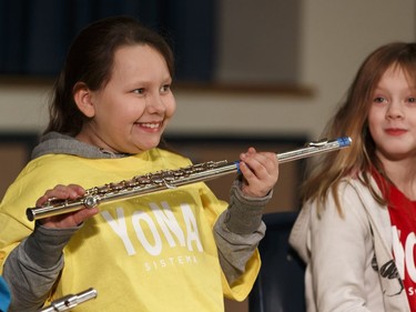 Florina, a music student in the Edmonton Symphony Orchestra and the Winspear Centre for Music's YONA-Sistema music program, exchanges her plastic practice instrument for a real flute during a ceremony at St. Alphonsus Catholic School in Edmonton, Alberta on Wednesday, December 7, 2016.