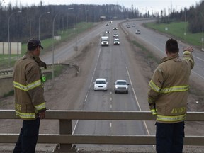 Fort McMurray firefighters greeted returning residents driving into the downtown on Highway 63 on June 1, 2016. It was the first day residents were allowed to return to the city one month after a massive wildfire forced them to evacuate.