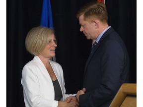 Premier Rachel Notley shakes hands on May 18, 2016, with leader of the opposition and Wildrose MLA for Fort McMurray-Conklin Brian Jean, during a press conference at the Provincial Operations Centre in Edmonton.