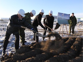 Steven Karpyshin, regional director of Western Canada for Defence Construction Canada, left, Michael Kazda, vice president of Ellis Don, Lt. Col. Corey Frederickson and Edmonton Mill Woods MP Amarjeet Sohi, who is also infrastructure minister, turn the sod to officially begin construction of a new Tactical Armoured Patrol Vehicle facility at Edmonton Garrison on Dec. 2, 2016.