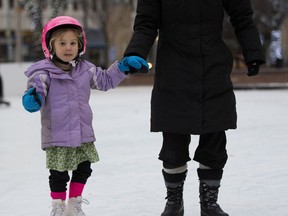 Henna Krupa ,4, gets a hand from her mom, Kathy Ochoa, as she skates for the second time in her life at the skating rink in front of City Hall on Sunday, December 4, 2016.