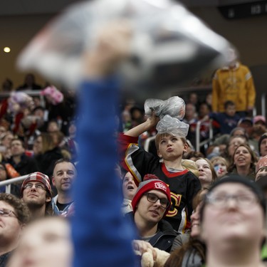 Fans dance with their donated toys during the 2016 Teddy Bear Toss game between the Edmonton Oil Kings and the Kamloops Blazers at Rogers Place in Edmonton, Alberta on Saturday, December 10, 2016. Ian Kucerak / Postmedia