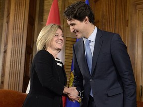 Prime Minister Justin Trudeau and Alberta Premier Rachel Notley shake hands during a meeting on Parliament Hill on Nov. 29, 2016 in Ottawa after Trudeau announced his government's decision on three pipeline projects — including approval of Kinder Morgan Trans Mountain and a "no" to Northern Gateway.