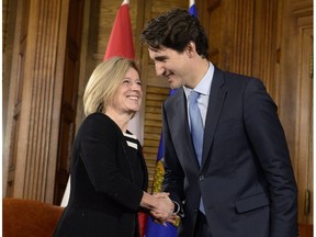 Prime Minister Justin Trudeau and Alberta Premier Rachel Notley (left) shake hands during a meeting on Parliament Hill, Tuesday, Nov. 29, 2016 in Ottawa.