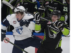 Edmonton Oil Kings Kyle Yewchuk get his stick caught in the helmet of Saskatoon Blades Luke Gingras during WHL action on Friday, December 2, 2016  in Edmonton.