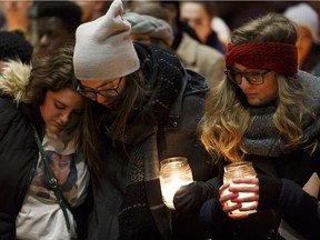 From left: Marlee Butti, Danielle Bourque and Dakota Bergem, friends and classmates of Rachael Longridge, a nurse killed on Dec. 23, 2016 took part in a candlelight vigil outside of the Edmonton Clinic Health Academy at the University of Alberta on Wednesday, December 28, 2016.