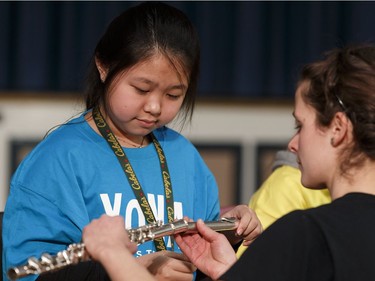 Lina, a music student with the Edmonton Symphony Orchestra and the Winspear Centre for Music's YONA-Sistema program receives a new flute during a ceremony at St. Alphonsus Catholic School in Edmonton, Alberta on Wednesday, December 7, 2016.