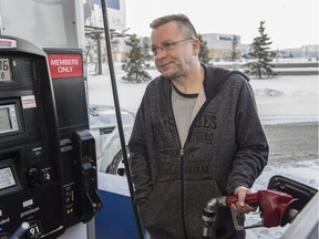 Marty Gillingwater filling his truck with gas on Saturday. Alberta's carbon tax kicks in on Jan. 1 and some Edmontonians are lining up at the Costco gas pumps in advance to save that 4.5 cents one more time on December 31, 2016.