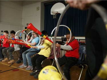 Music students in the Edmonton Symphony Orchestra and the Winspear Centre for Music's YONA-Sistema music  program play their practice instruments for the last time before receiving real instruments during a ceremony at St. Alphonsus Catholic School in Edmonton, Alberta on Wednesday, December 7, 2016.