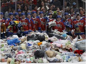 Oil Kings players pose for a photo with thousands of donated toys during the 2016 Teddy Bear Toss game between the Edmonton Oil Kings and the Kamloops Blazers at Rogers Place in Edmonton, Alberta on Saturday, December 10, 2016.