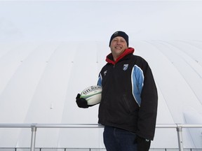 Pandas women's rugby head coach Matt Parrish poses for a photo next to the new inflatable dome at Foote Field at the University of Alberta in Edmonton, Alberta on Tuesday, December 6, 2016.