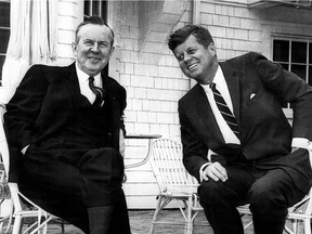 Canadian Prime Minister Lester Pearson warms his hands in his pockets as he chats with President John Kennedy for benefit of photographers on the terrace of the President's summer home at Hyannis Port on Cape Cod, May 10, 1963. THE CANADIAN PRESS/AP, files