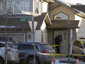 Police investigate a home on Hanley Court in Spruce Grove on Dec. 19, 2016, where the bodies of three people were discovered.