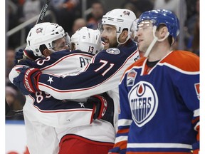 Columbus Blue Jackets' Sam Gagner (89), Cam Atkinson (13) and Nick Foligno (71) celebrate goal as Edmonton Oilers' Mark Letestu (55) skates past during third period NHL action in Edmonton, Alta., on Tuesday December 13, 2016.