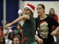 Educational assistant Briony Oliver (left) and teacher Lindsay Kristiansen (right) get into the Christmas spirit by participating in a sock fight against the students at St. Martha Catholic Elementary School in Edmonton on December 16, 2016.