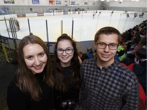 Vimy Ridge Academy students Victoria Wright (left), Erika Hurl (centre) and Alexander Wright (right), received Duke of Edinburgh Awards during a school hockey game between teachers and students at Kenilworth Arena in Edmonton, Alberta on Friday, December 23, 2016.