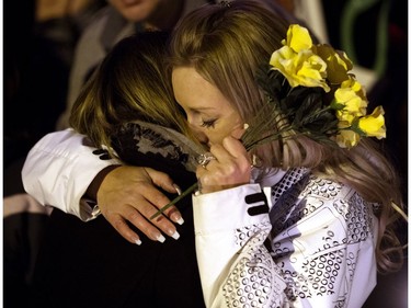 Tracy Stark (right) is embraced by a woman during a candlelight vigil for her sons Radek and Ryder MacDougall in Spruce Grove Thursday, Dec. 22, 2016. The two boys were were found dead in their Spruce Grove home on Monday, Dec. 19, 2016.