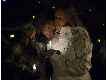 Tracy Stark (right) is embraced by a woman during a candlelight vigil for her sons Radek MacDougall and Ryder MacDougall, in Spruce Grove Thursday Dec. 22, 2016. The two boys were were found dead in their Spruce Grove home on Monday Dec. 19, 2016. Photo by David Bloom