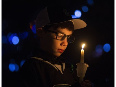A teammate of Radek MacDougall takes part in a candlelight vigil for Radek and his brother Ryder MacDougall, in Spruce Grove Thursday Dec. 22, 2016. The two boys were were found dead in their Spruce Grove home on Monday Dec. 19, 2016. Photo by David Bloom