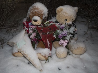 Two teddy bears in hockey jerseys sit outside the Whitecourt home of Radek and Ryder MacDougall on Tuesday, Dec. 20, 2016.
