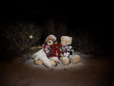 Two teddy bears in hockey jerseys sit outside the Whitecourt , Alta home of Radek MacDougall and Ryder MacDougall, Tuesday Dec. 20, 2016. The two boys were were found dead in their Spruce Grove home on Monday Dec. 19, 2016.