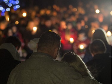 Brent Stark and Tracy Stark watch a candlelight vigil for their sons Radek MacDougall and Ryder MacDougall, in Whitecourt on Tuesday Dec. 20, 2016. The two boys were were found dead in their Spruce Grove home on Monday Dec. 19, 2016.