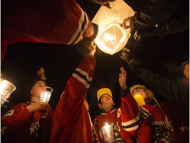 Young hockey players launch a paper lantern during the candlelight vigil for Radek MacDougall and Ryder MacDougall, in Whitecourt on Tuesday Dec. 20, 2016. The two boys were were found dead in their Spruce Grove home on Monday Dec. 19, 2016.