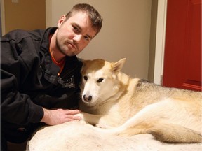 William Gibb of Red Deer cuddles up with his five-year-old husky Sasha at home on Wednesday, December 28, 2016. On Boxing Day, Gibb rescued Sasha from the jaws of a Cougar, beating it with his fists and a stick outside a Tim Hortons Restaurant in Whitecourt.