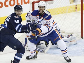 Winnipeg Jets' Mark Scheifele (55) and Edmonton Oilers' Darnell Nurse (25) fight for position in front of Oilers goaltender Cam Talbot (33) during first period NHL action in Winnipeg on Thursday, December 1, 2016.