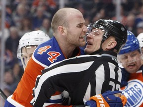 Edmonton Oilers' Zack Kassian is held back by a referee while playing against the Tampa Bay Lightning at Rogers Place onDec. 17. (The Canadian Press)