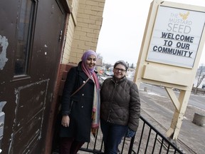 Zeina Sleiman (left) and Marlene Mulder pose for a photo outside the Mustard Seed Church in Edmonton, Alberta on Friday, December 23, 2016.