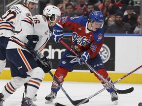 Edmonton Oil Kings centre Lane Bauer, right, battles with Nick Chyzowski, centre, and Quinn Benjafield of the Kamloops Blazers at Rogers Place on Saturday, December 10, 2016. Bauer was traded to the Blazers on Thursday. (File)