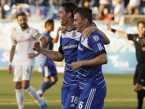 Edmonton's Daryl Fordyce (16) celebrates Nik Ledgerwood's (6) goal during NASL soccer play between FC Edmonton and the New York Cosmos at Clarke Stadium in Edmonton, on Wednesday, July 27, 2016.