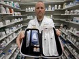 University of Alberta Pharmacist Aaron Walker holds a take-home naloxone kit, at the University Health Centre Pharmacy. File photo.