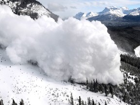 This photo from Dec. 23, 2013, shows an explosive-triggered avalanche above a highway in Banff National Park.