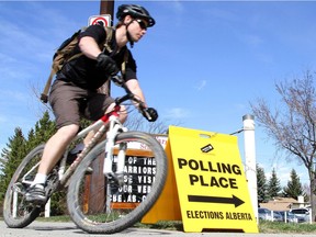 Brandon Hagel rides his bike to the polling station on a warm election day. File photo.