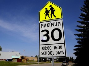 A school zone sign outside St. Martha Catholic School at 7240 180 St., In Edmonton on Monday Aug. 25, 2014. School zone signs are going up around city junior high schools in preparation for the 2017-18 school year.