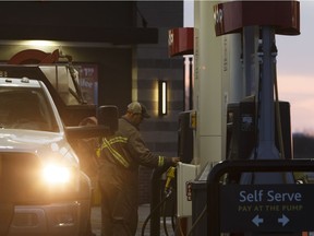 A driver fills up at an Co-op gas station on the Alberta side of the border in Lloydminster, Alberta on Thursday, December 22, 2016. The carbon tax applies only on the Alberta side of the border, which divides the prairie city.