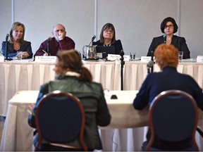 The Alberta Electoral Boundaries Commission made up of Gwen Day, left, W. Bruce McLeod, chair Justice Myra Bielby, Laurie Livingstone and D. Jean Munn, out of frame, listen to the public as it began its boundary hearings at the Ramada Kingsway in Edmonton on  Jan. 16, 2017.