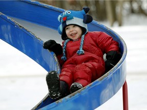 Ava Berger, three, plays on the slide at Victoria Park in Edmonton on Wednesday January 18, 2017 as temperatures reached a balmy 9C degrees.