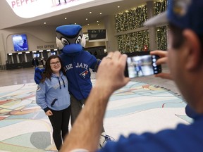 Breanna Winegarden (left), 12, gets a photo taken by her father Charles with Blue Jays mascot Ace before meeting Toronto Blue Jays players Kevin Pillar, Devon Travis, Aaron Sanchez and Marco Estrada during a Blue Jays 2017 Winter Tour stop at Rogers Place in Edmonton, Alberta on Friday, January 13, 2017.