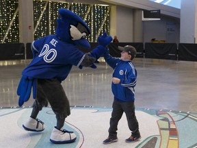 Charlie Winegarden, 9, high-fives Blue Jays mascot Ace before meeting Toronto Blue Jays players Kevin Pillar, Devon Travis, Aaron Sanchez and Marco Estrada during a Blue Jays 2017 Winter Tour stop at Rogers Place in Edmonton on Friday, Jan. 13, 2017.