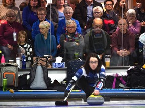 Curling fans watch skip Val Sweeting throw her rock playing against Team Baird during the Alberta Scotties Tournament of Hearts provincial championship at the St. Albert Curling Club, Thursday, January 25, 2017.