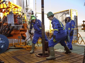 Trainees lay down drill pipe in Nisku last year.