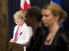 Media Relations Director Cheryl Oates, listens to Premier Rachel Notley speak on Dec. 10, 2015, in Edmonton. File Photo.