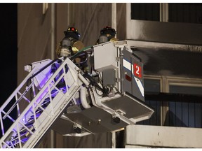 Edmonton Fire Service firefighters work a fire at the Oliver Place apartment complex at 117 Street and Jasper Avenue in Edmonton, Alberta on Thursday, January 19, 2017. Five hundred people were evacuated in the two-alarm fire.